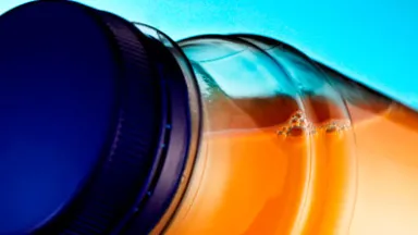 Orange liquid inside of a plastic bottle